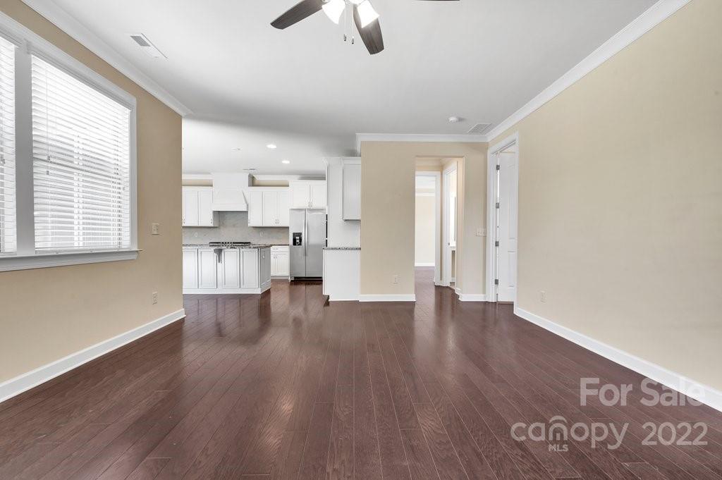 1271 Independence Street Tega Cay, SC 29708 - Photo 12 of 23 a view of empty room with wooden floor and window