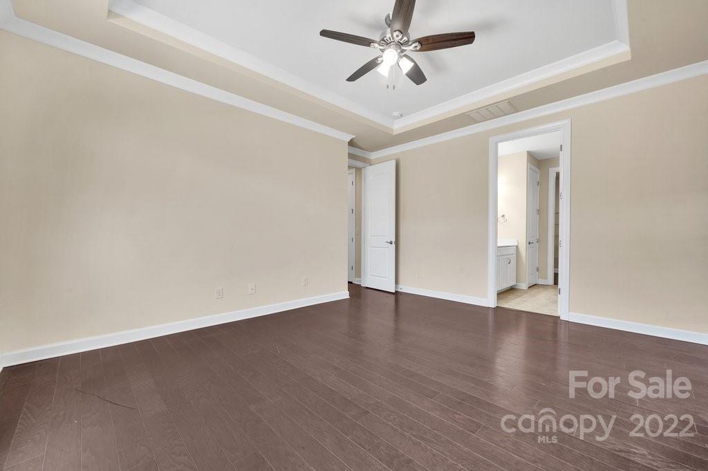 1271 Independence Street Tega Cay, SC 29708 - Photo 17 of 23 an empty room with wooden floor closet and fan