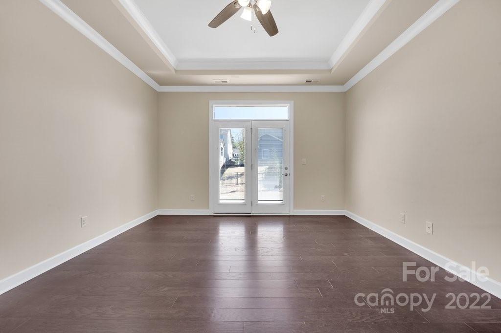 1271 Independence Street Tega Cay, SC 29708 - Photo 18 of 23 an empty room with wooden floor and windows