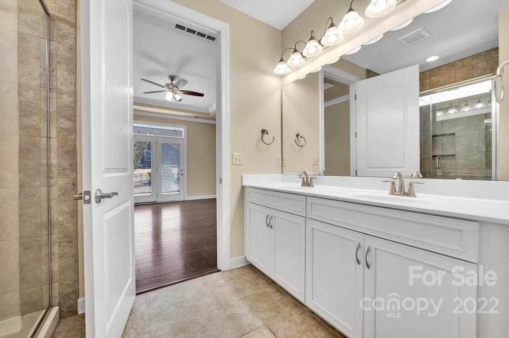 1271 Independence Street Tega Cay, SC 29708 - Photo 19 of 23 a bathroom with a double vanity sink and a mirror