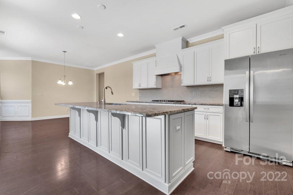 1271 Independence Street Tega Cay, SC 29708 - Photo 7 of 23 a kitchen with stainless steel appliances granite countertop a white cabinets a sink a stove a refrigerator and white cabinets
