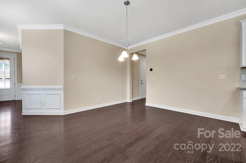 1271 Independence Street Tega Cay, SC 29708 - Photo 10 of 23 a view of an empty room with wooden floor and a window