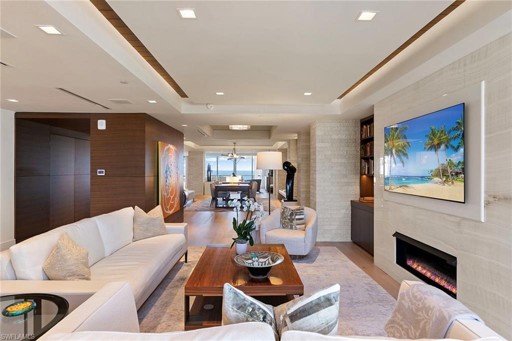 6897 Grenadier Boulevard, Unit 902 Naples, FL 34108 - Photo 21 of 50 a living room with furniture and a fireplace