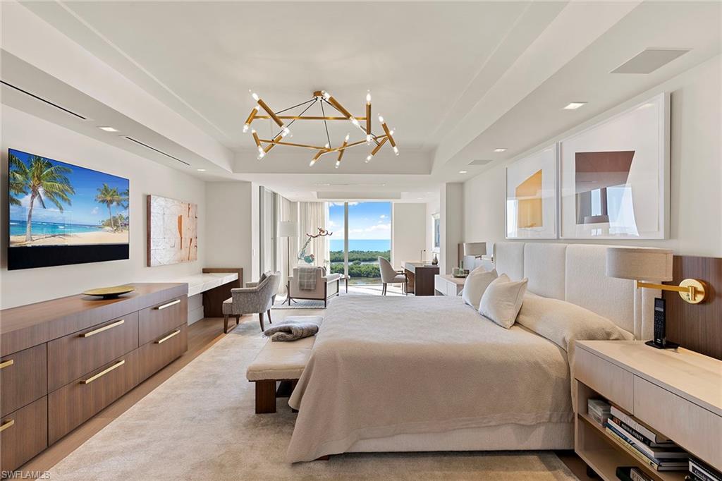 6897 Grenadier Boulevard, Unit 902 Naples, FL 34108 - Photo 24 of 50 a bedroom with a bed and glass windows