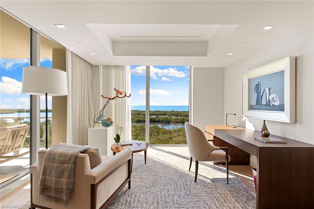 6897 Grenadier Boulevard, Unit 902 Naples, FL 34108 - Photo 25 of 50 a living room with furniture and a window