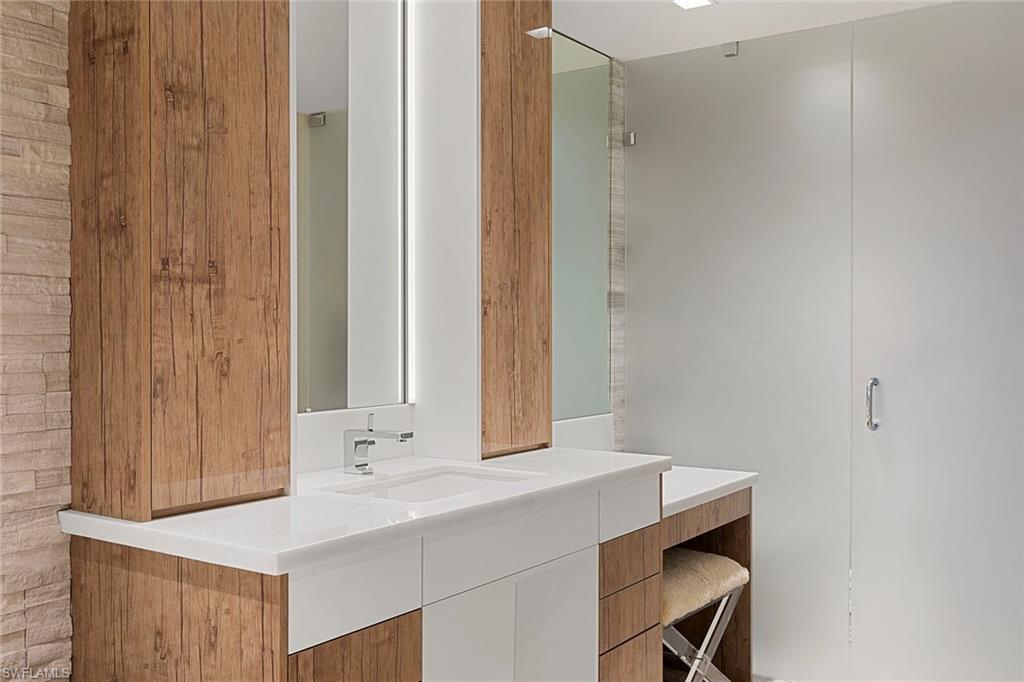 6897 Grenadier Boulevard, Unit 902 Naples, FL 34108 - Photo 29 of 50 a bathroom with a sink and a mirror