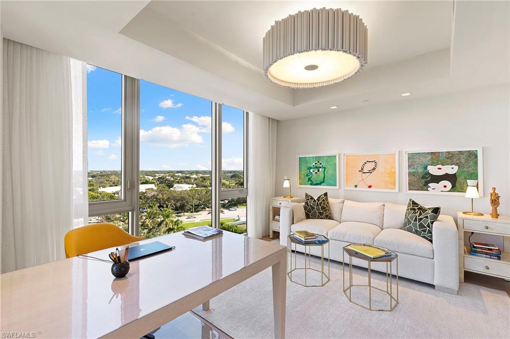 6897 Grenadier Boulevard, Unit 902 Naples, FL 34108 - Photo 31 of 50 a living room with furniture and a large window