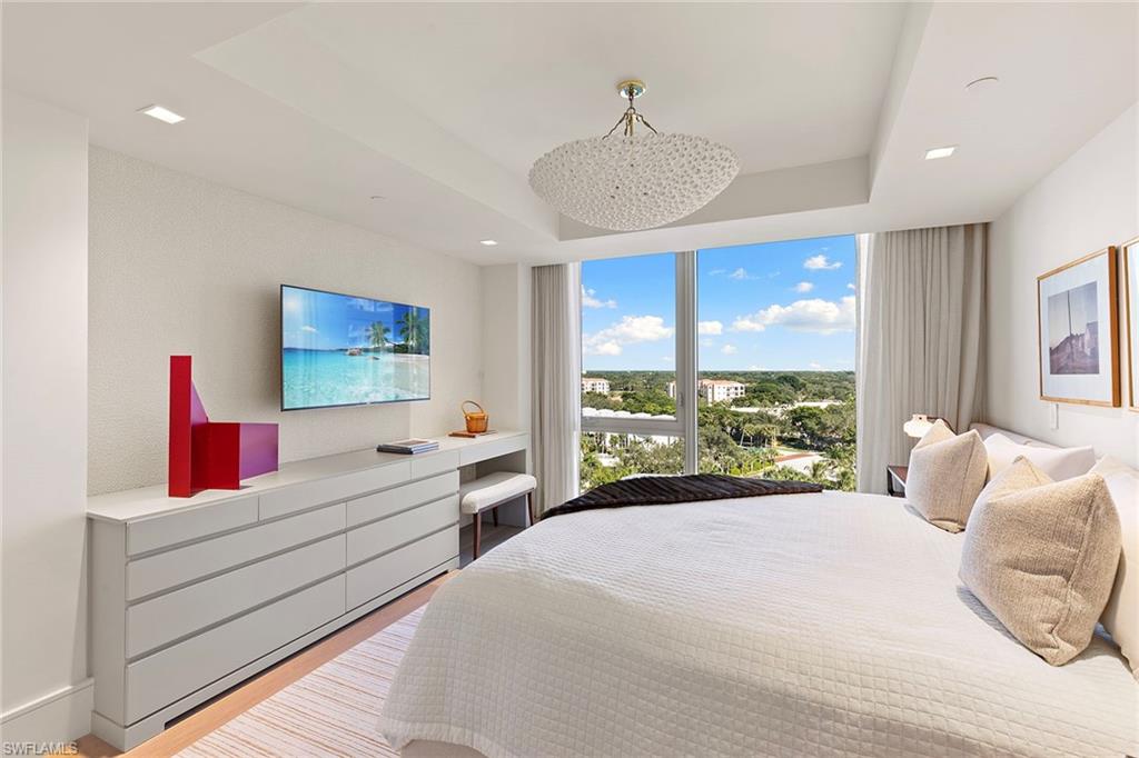 6897 Grenadier Boulevard, Unit 902 Naples, FL 34108 - Photo 33 of 50 a bedroom with a bed and a large window