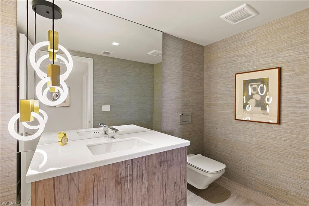 6897 Grenadier Boulevard, Unit 902 Naples, FL 34108 - Photo 36 of 50 a bathroom with a sink a toilet and shower