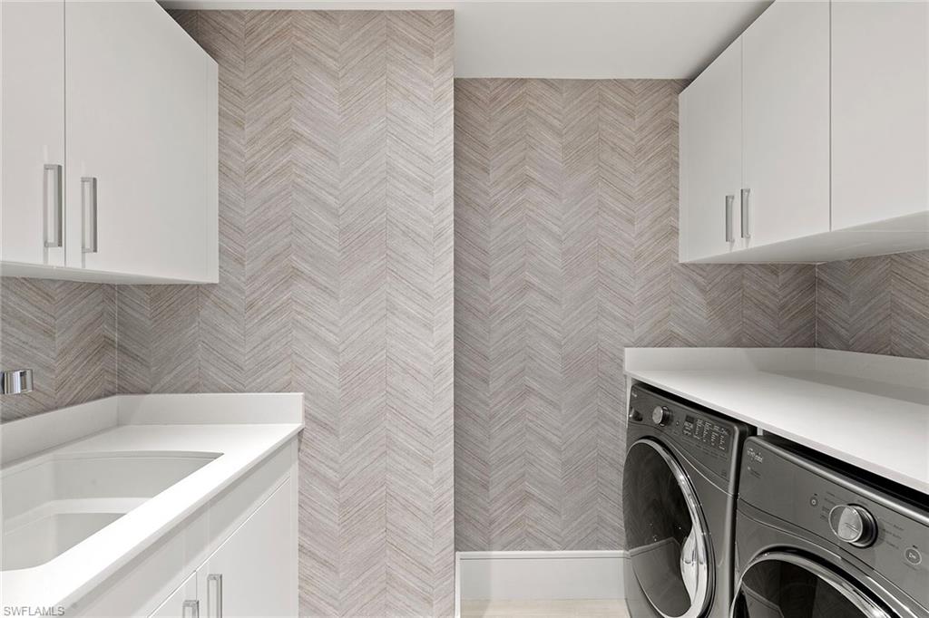 6897 Grenadier Boulevard, Unit 902 Naples, FL 34108 - Photo 37 of 50 a utility room with cabinets