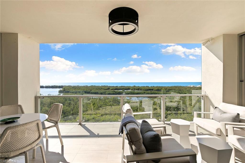 6897 Grenadier Boulevard, Unit 902 Naples, FL 34108 - Photo 39 of 50 a view of a balcony with table and chairs