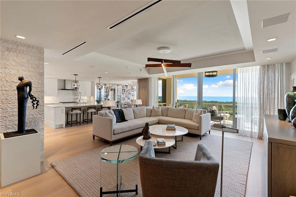 6897 Grenadier Boulevard, Unit 902 Naples, FL 34108 - Photo 7 of 50 a living room with furniture and a large window