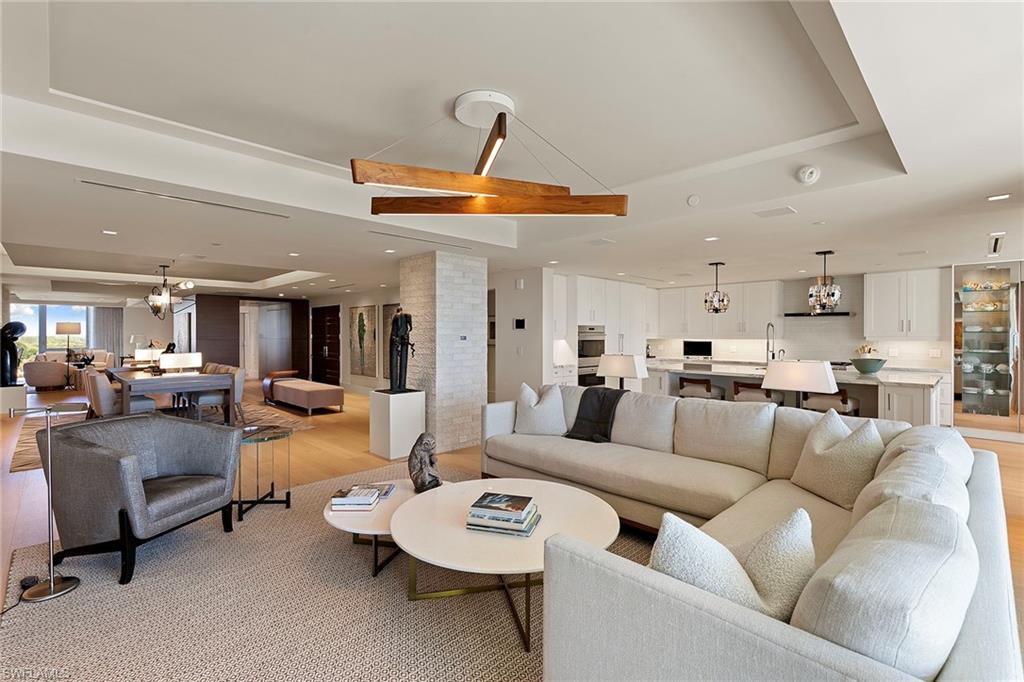 6897 Grenadier Boulevard, Unit 902 Naples, FL 34108 - Photo 9 of 50 a living room with furniture and kitchen view