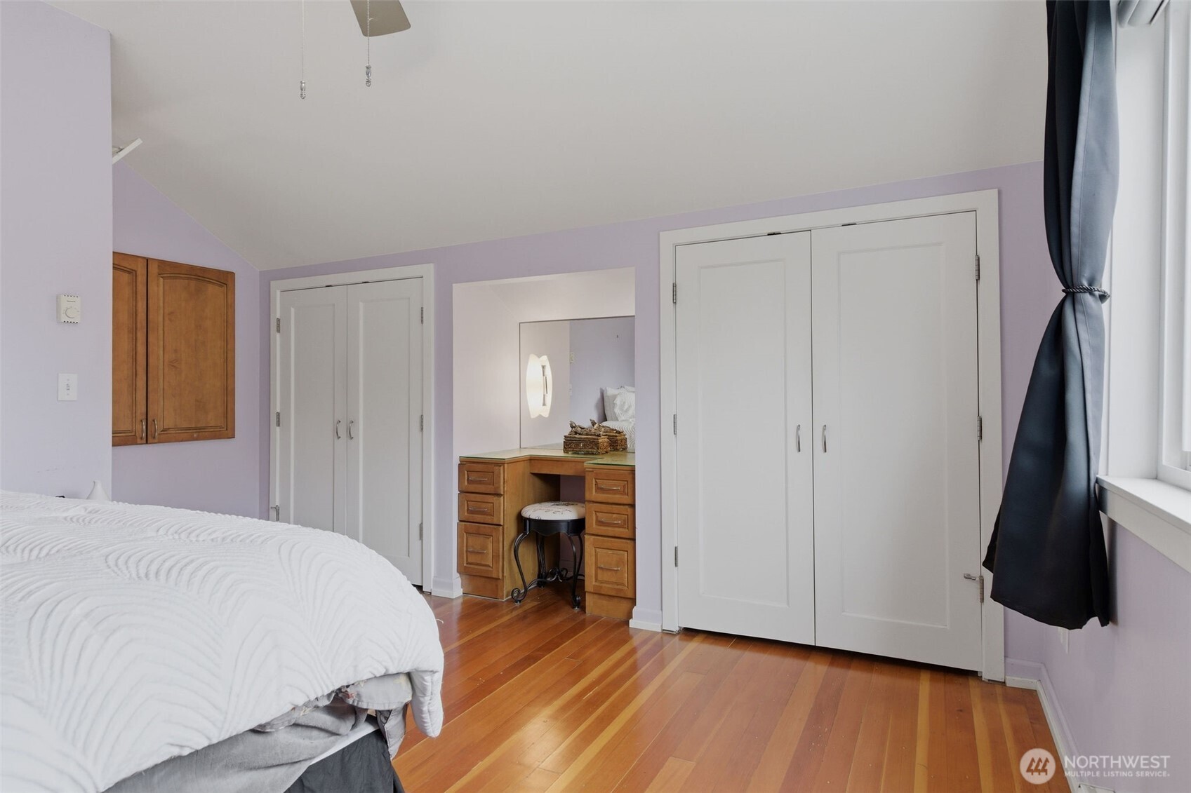 9272 Fauntleroy Way Southwest Seattle, WA 98136 - Photo 18 of 35 a bedroom with a bed and a flat tv screen on wall