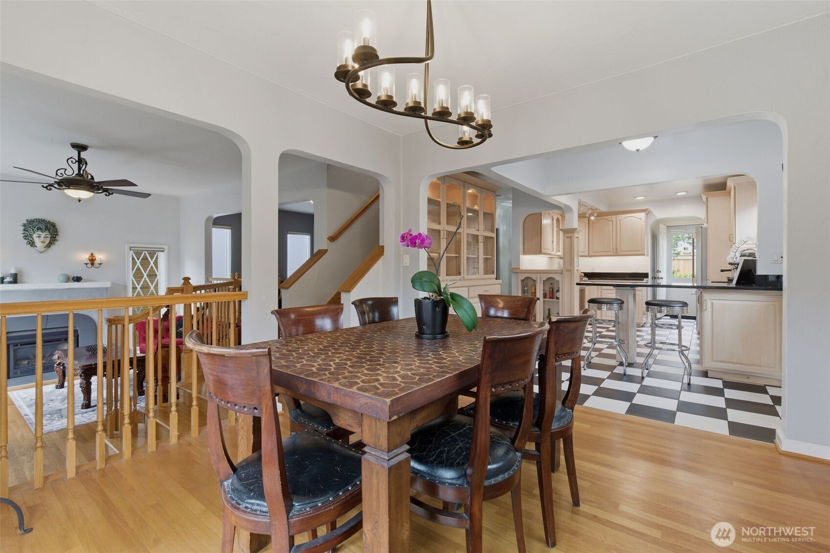 9272 Fauntleroy Way Southwest Seattle, WA 98136 - Photo 5 of 35 a dining room with wooden floor a chandelier a wooden table and chairs