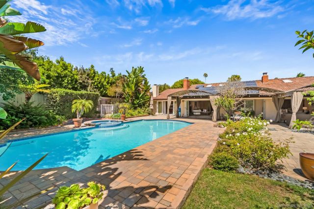 a house with swimming pool in front of it