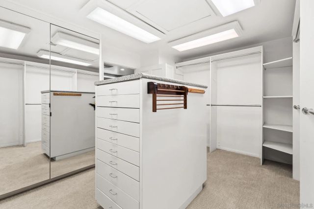 a bedroom with bed and a chandelier