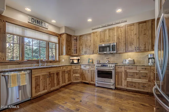 a view of a hallway with wooden floor and front door