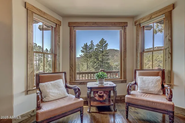 a view of a dining room with furniture a chandelier and wooden floor