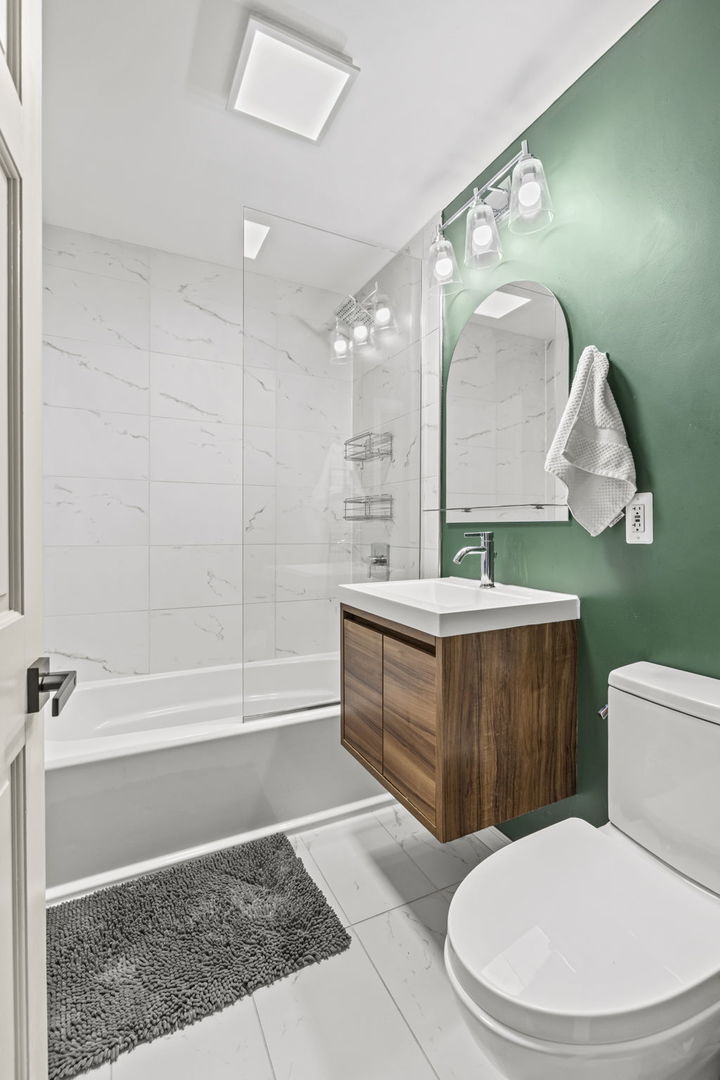 620 Crest Street Wheaton, IL 60187 - Photo 25 of 44 a bathroom with a sink a mirror a toilet and bathtub