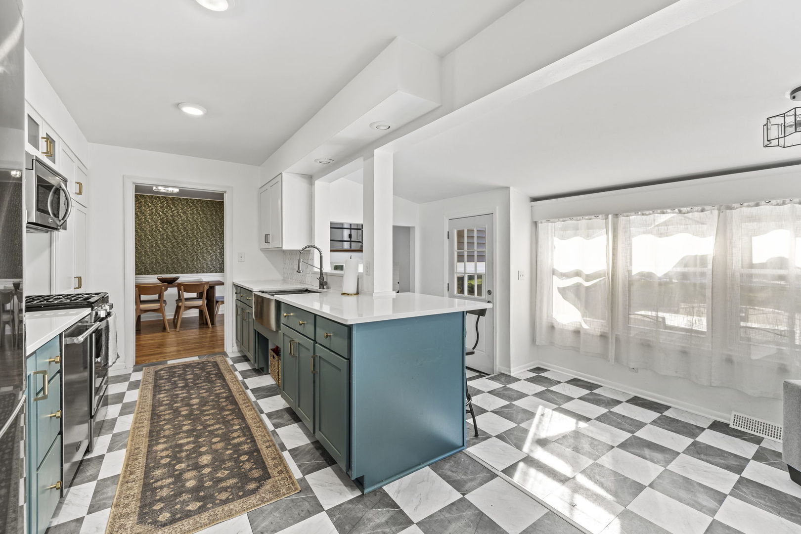 620 Crest Street Wheaton, IL 60187 - Photo 9 of 44 a large kitchen with kitchen island granite countertop a large window in it