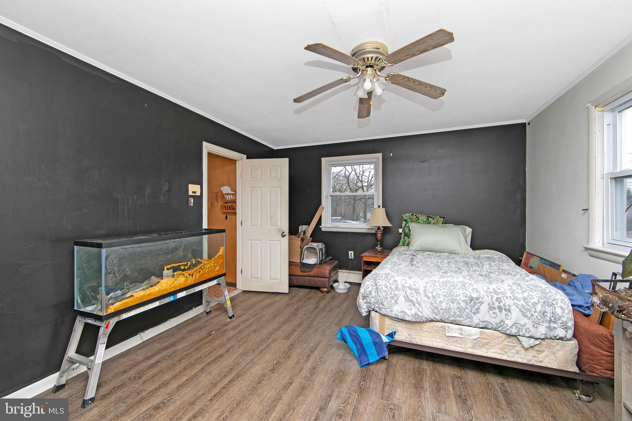 15 East Spring Street Pine Hill, NJ 08021 - Photo 12 of 38 a bedroom with a bed and wooden floor