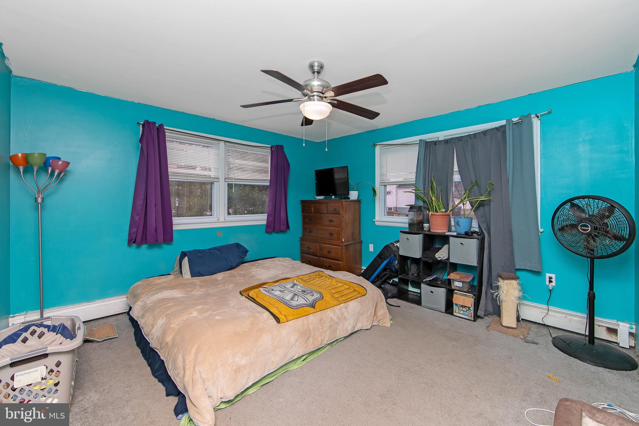 15 East Spring Street Pine Hill, NJ 08021 - Photo 14 of 38 a bed room with a bed and a chandelier