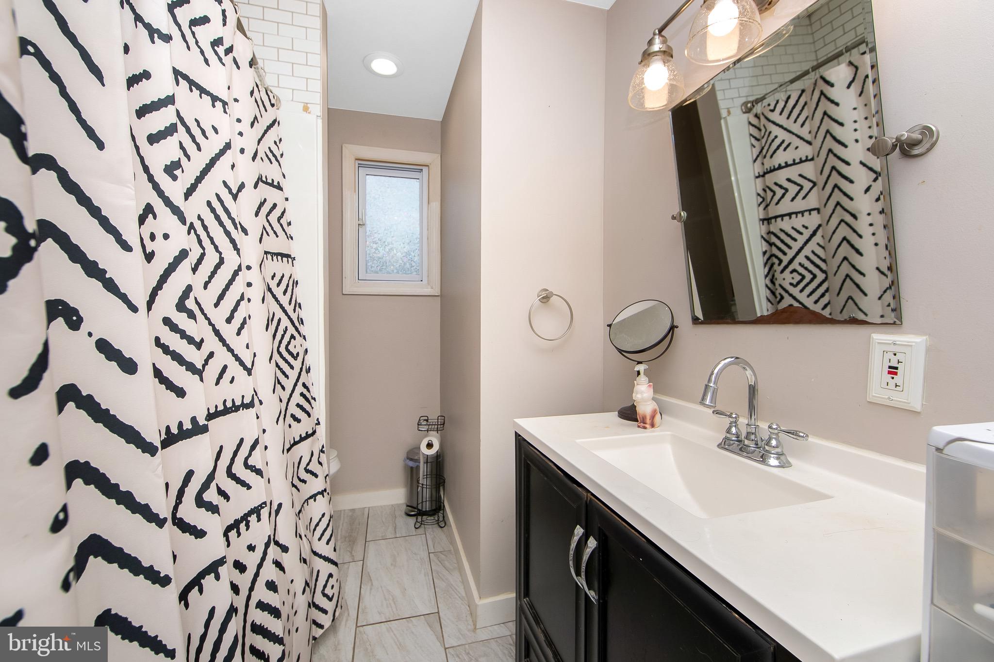 15 East Spring Street Pine Hill, NJ 08021 - Photo 23 of 38 a bathroom with a sink and a mirror