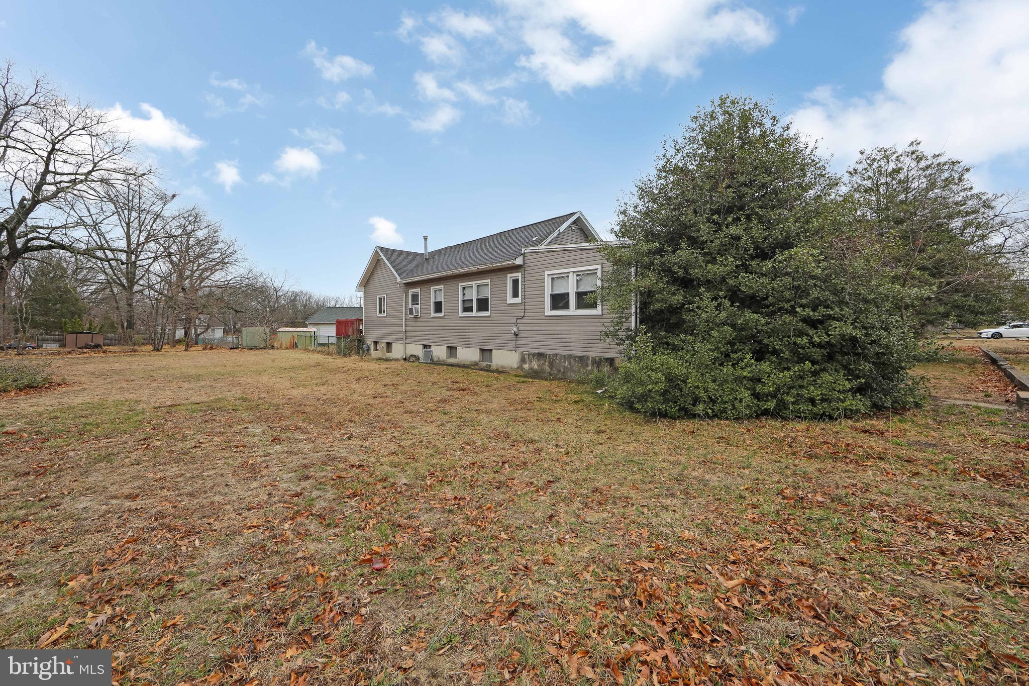 15 East Spring Street Pine Hill, NJ 08021 - Photo 28 of 38 a view of house with yard and trees in the background
