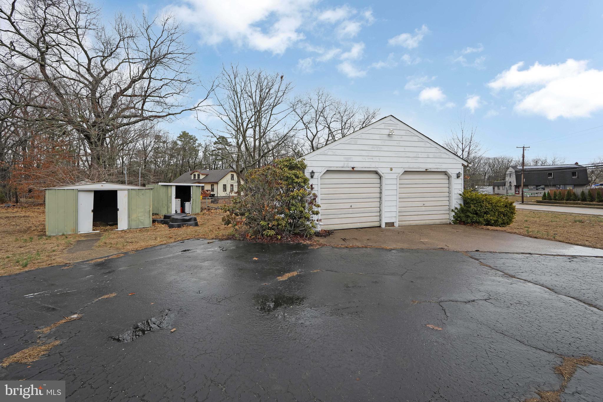 15 East Spring Street Pine Hill, NJ 08021 - Photo 34 of 38 a view of a house with a yard and garage