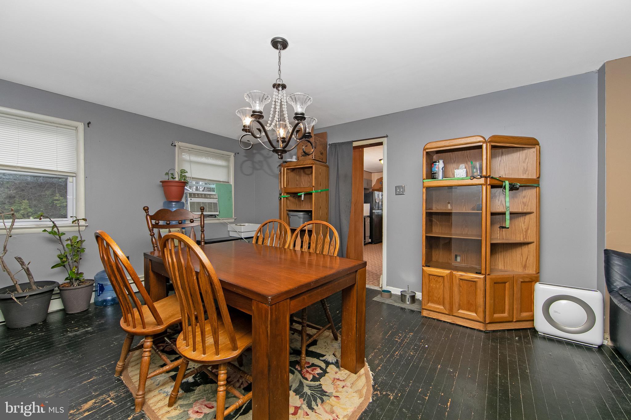 15 East Spring Street Pine Hill, NJ 08021 - Photo 5 of 38 a view of a dining room with furniture and wooden floor