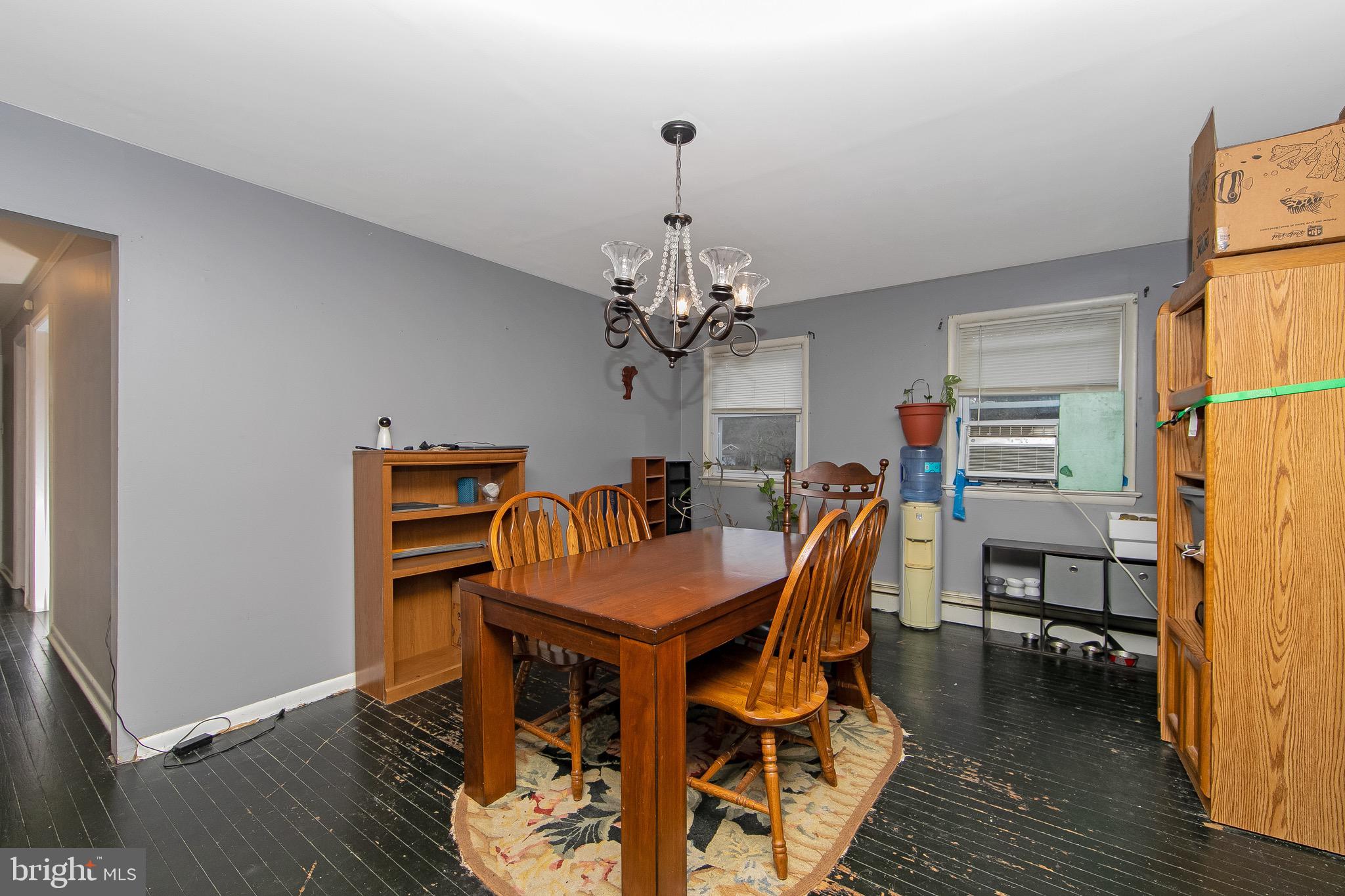 15 East Spring Street Pine Hill, NJ 08021 - Photo 7 of 38 a dining room with furniture a chandelier and wooden floor