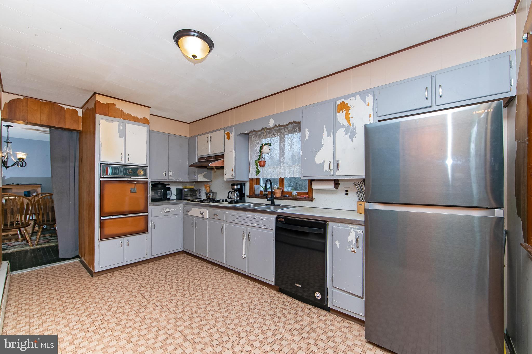 15 East Spring Street Pine Hill, NJ 08021 - Photo 9 of 38 a kitchen with a refrigerator and a sink