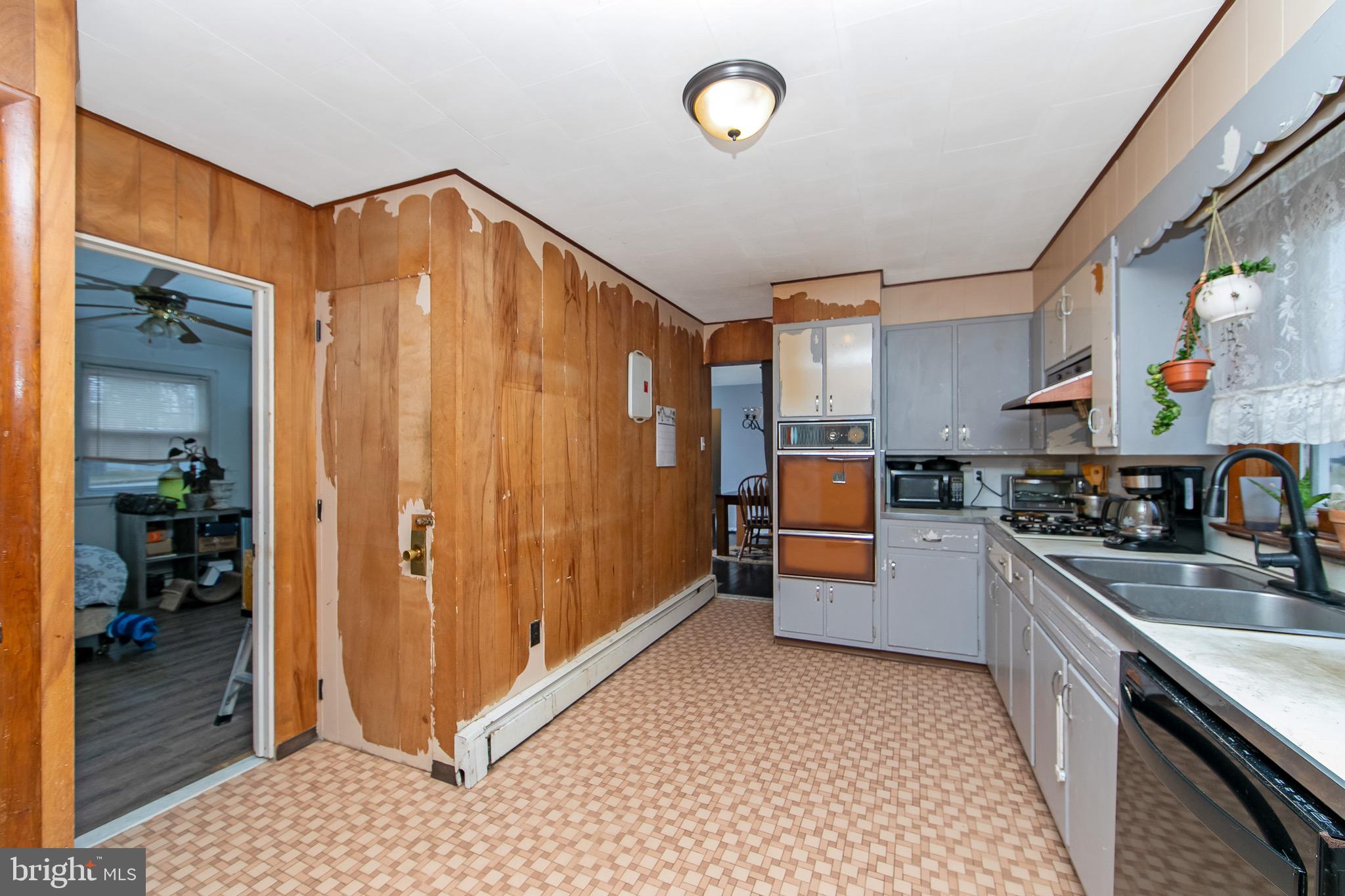 15 East Spring Street Pine Hill, NJ 08021 - Photo 10 of 38 a kitchen with stainless steel appliances granite countertop a refrigerator and a sink