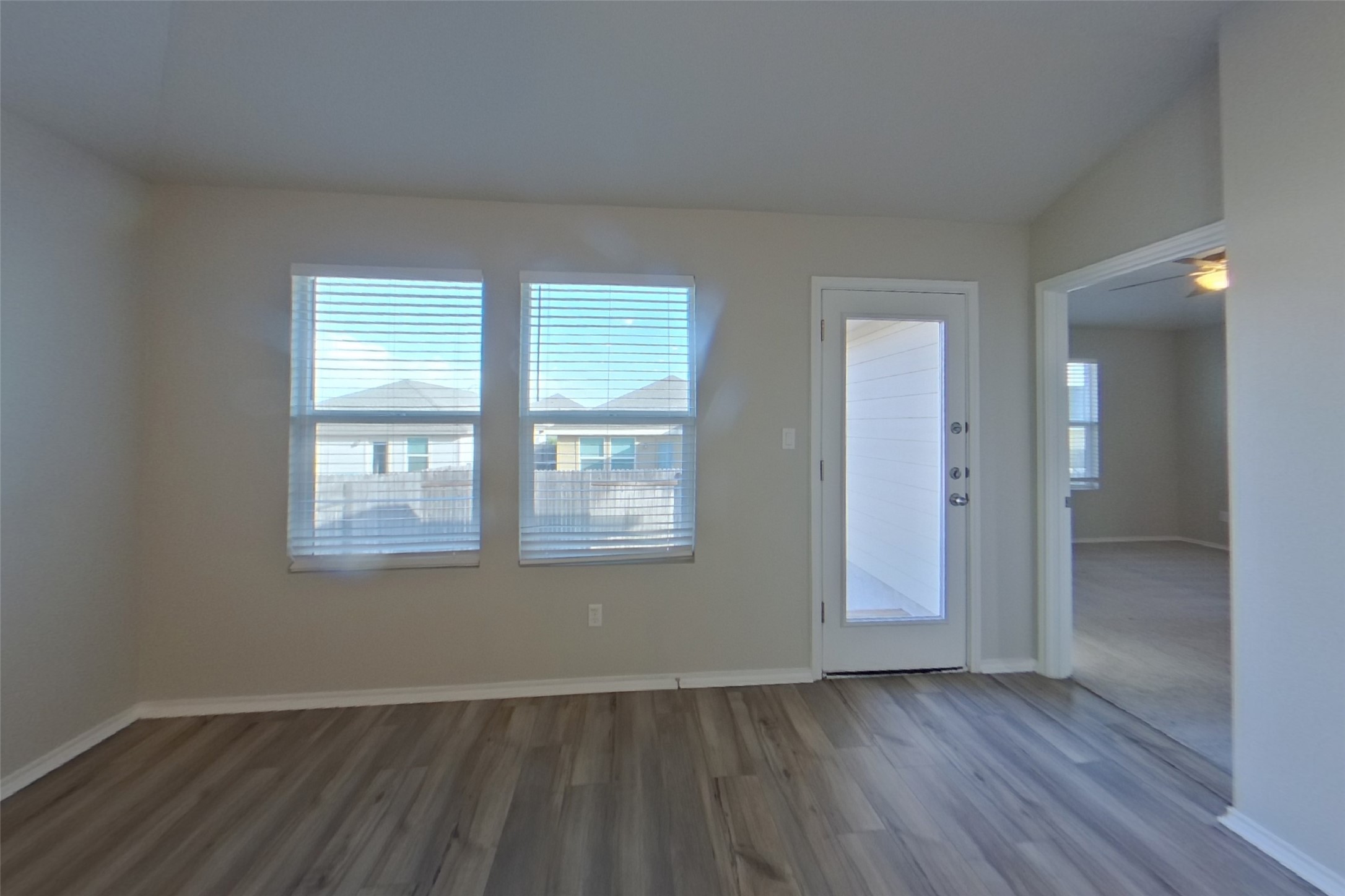 3525 Catlett Crk Road Georgetown, TX 78626 - Photo 2 of 16 Smooth wood-look flooring and multiple windows create an inviting, open atmosphere in this living area.