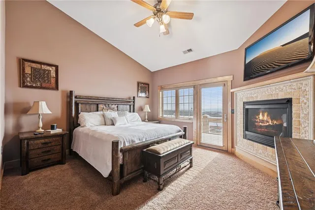 a bedroom with a bed and a tv on the dresser