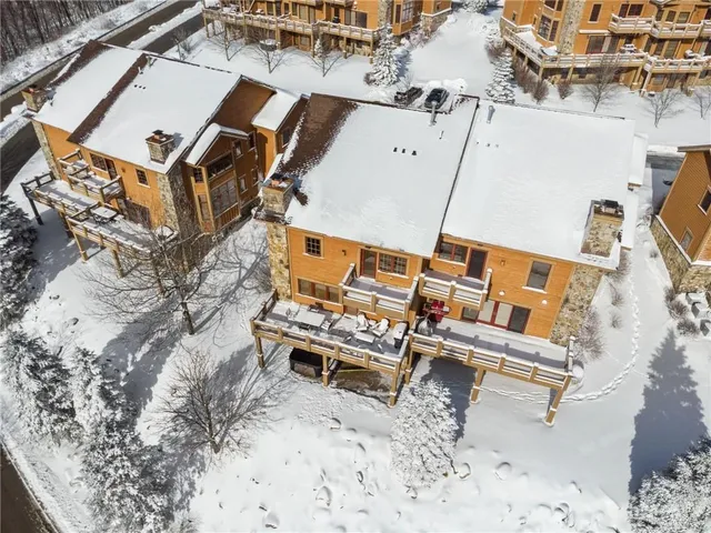 an aerial view of a house with swimming pool and outdoor space