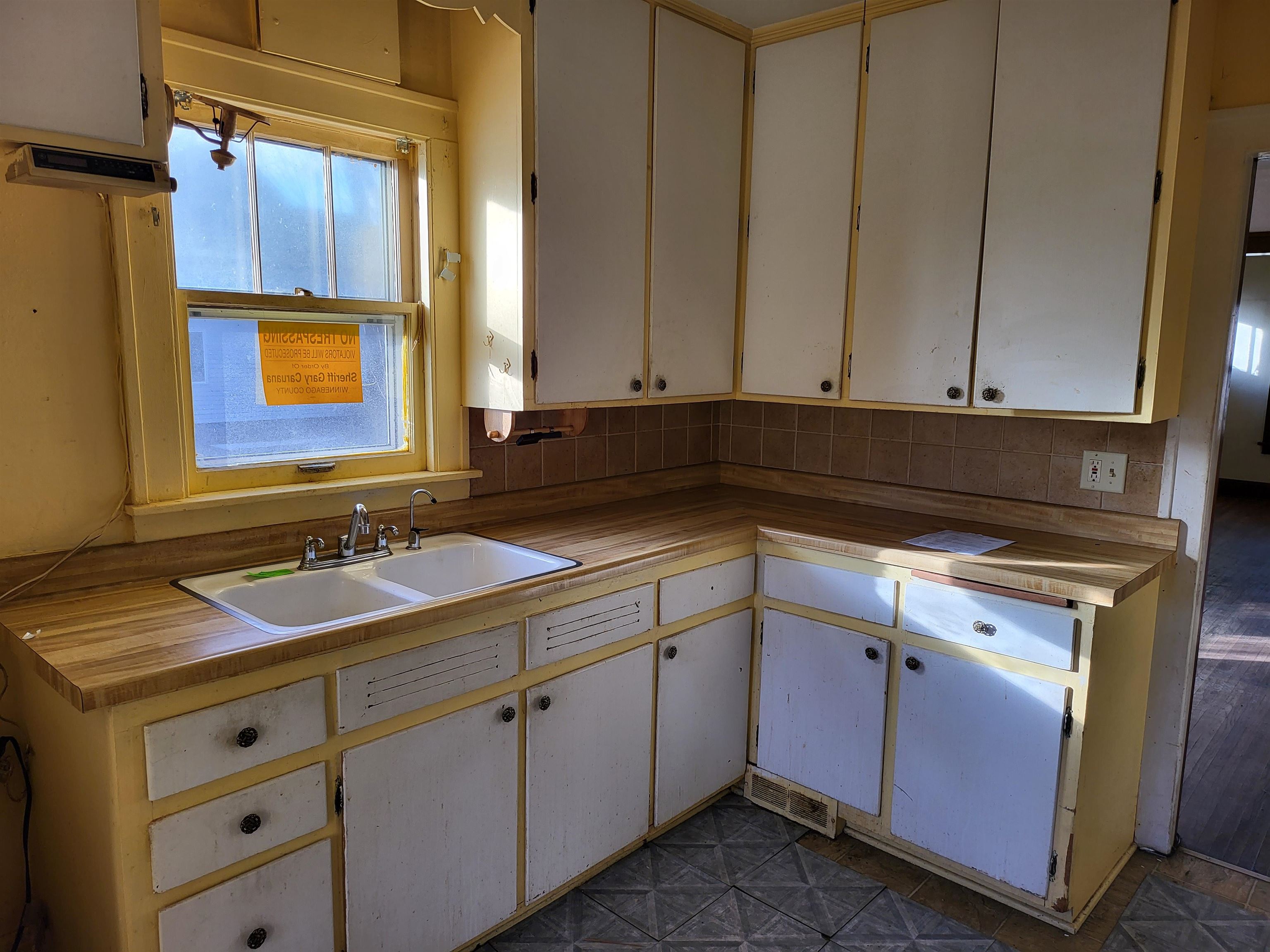 1803 Ridge Avenue Rockford, IL 61103 - Photo 3 of 11 a kitchen with a sink and cabinets
