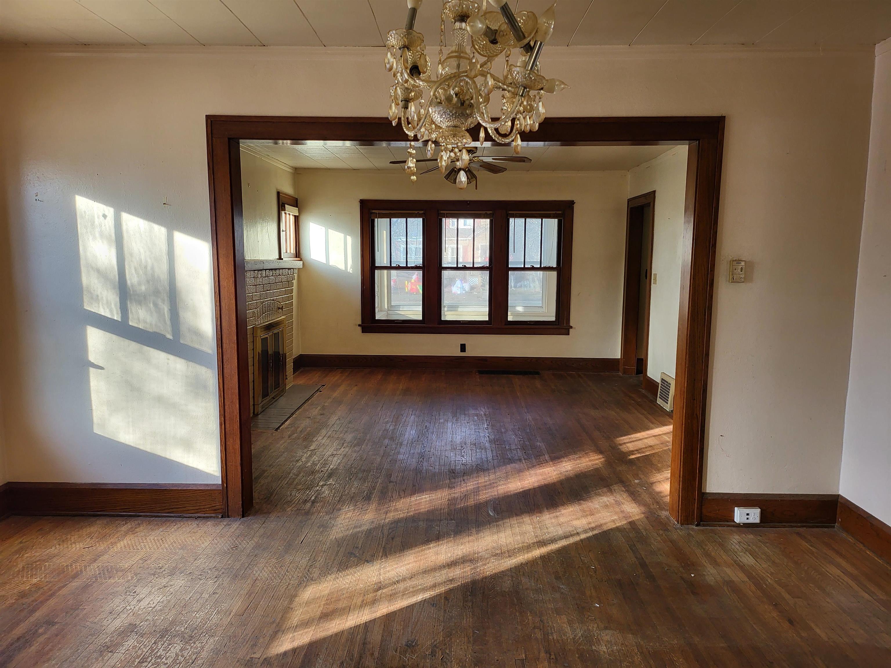 1803 Ridge Avenue Rockford, IL 61103 - Photo 4 of 11 a view of an empty room with wooden floor and a window