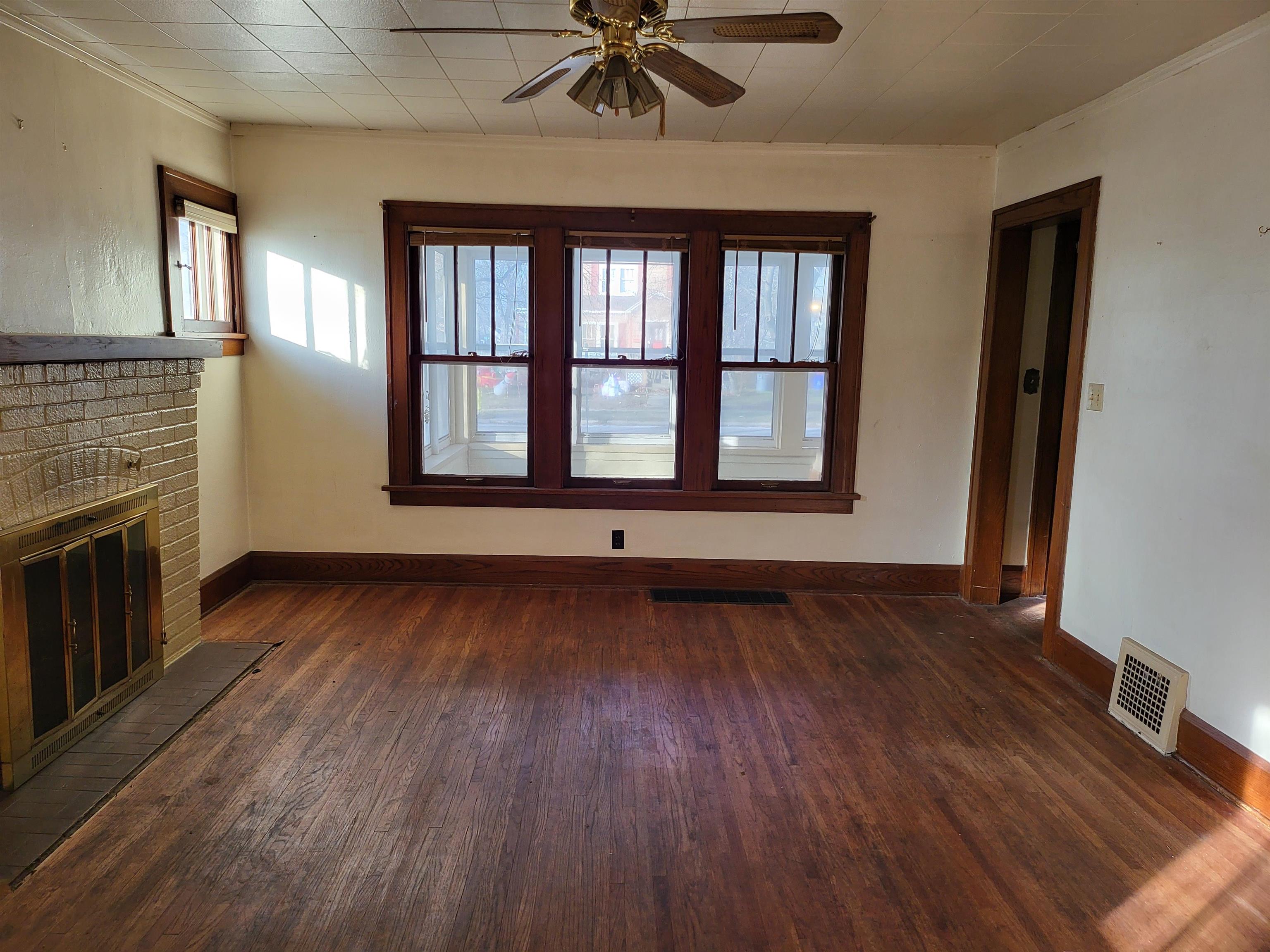 1803 Ridge Avenue Rockford, IL 61103 - Photo 6 of 11 a view of an empty room with a window and wooden floor