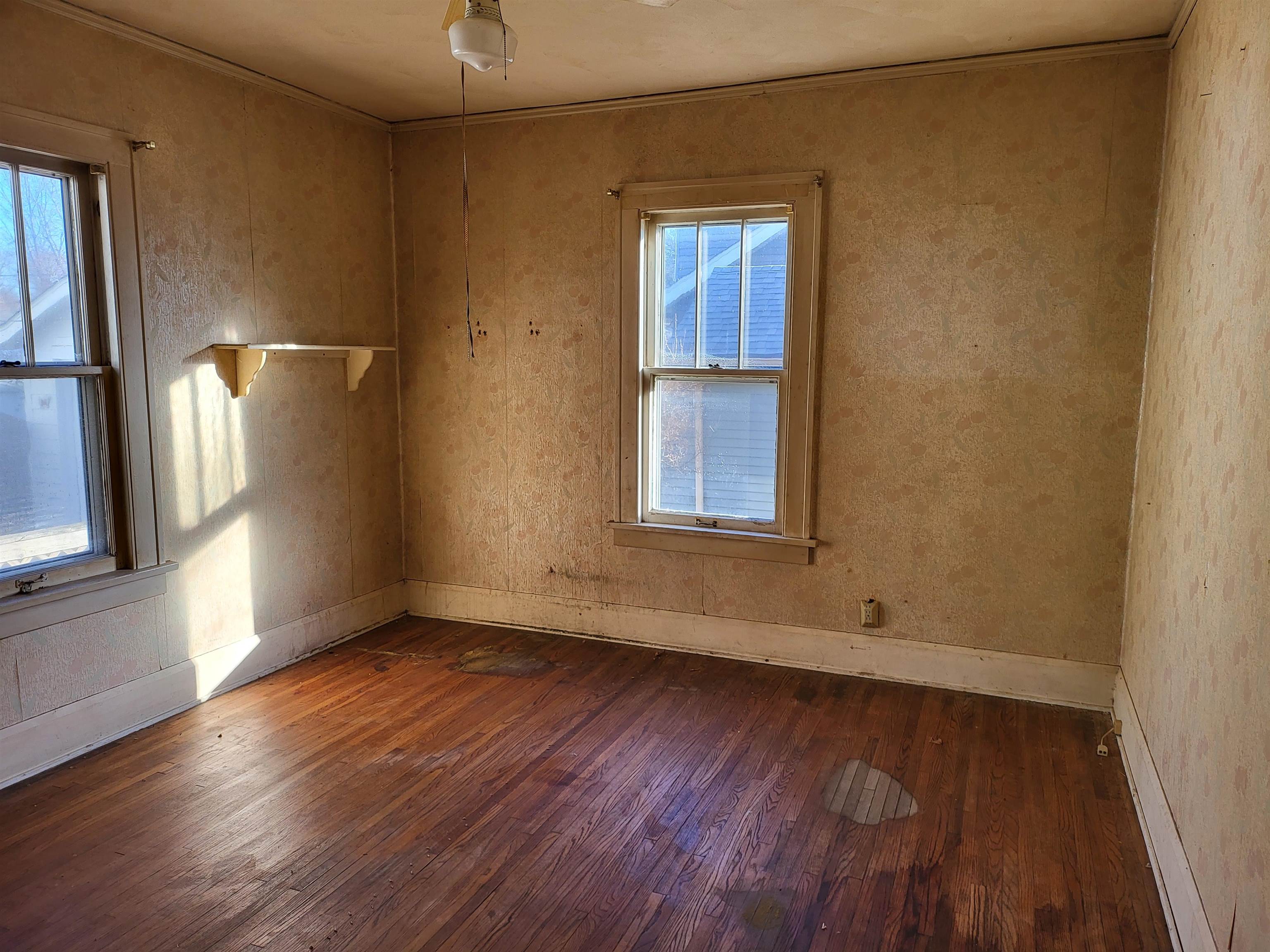 1803 Ridge Avenue Rockford, IL 61103 - Photo 8 of 11 an empty room with wooden floor and windows