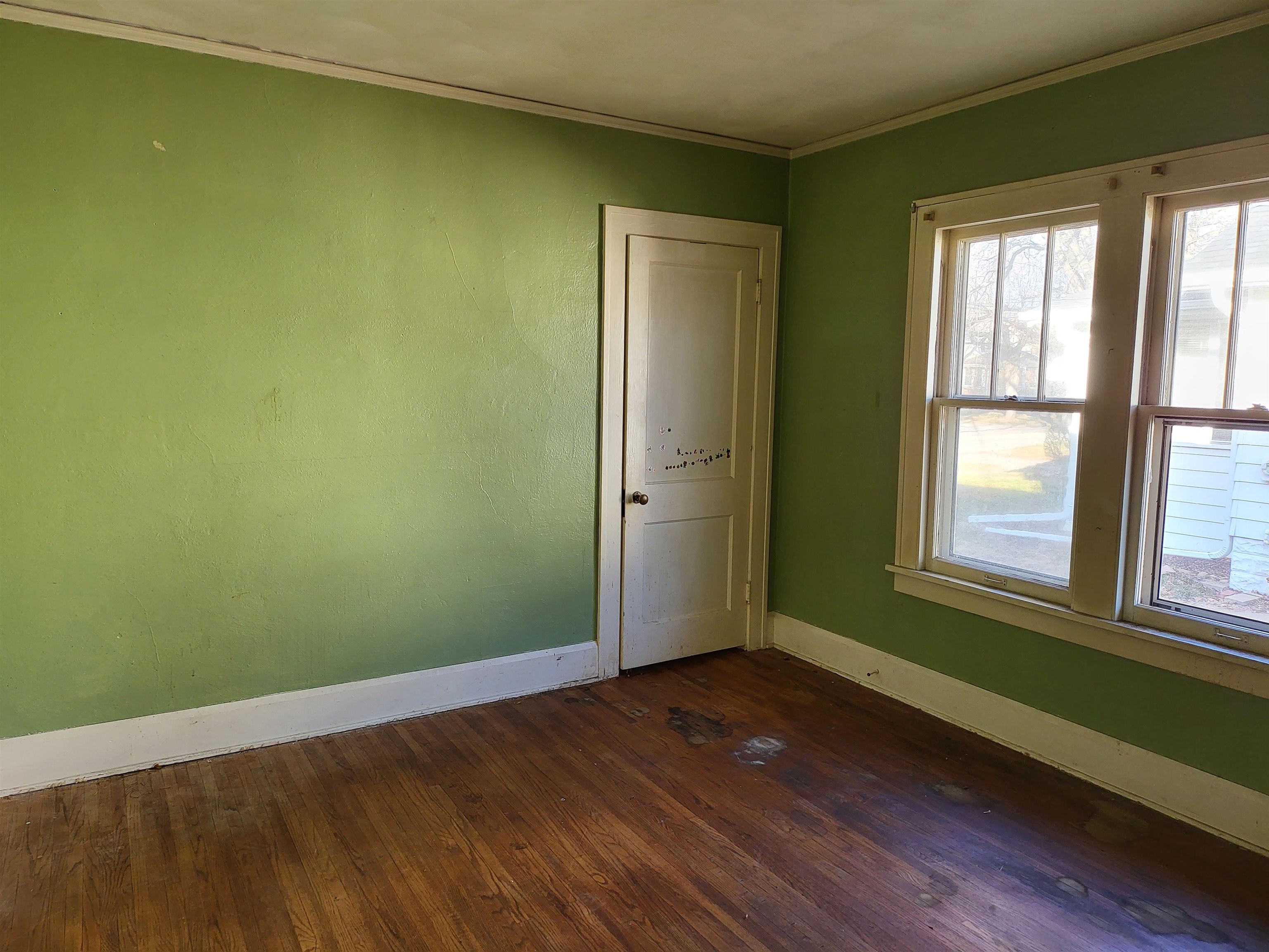 1803 Ridge Avenue Rockford, IL 61103 - Photo 9 of 11 an empty room with wooden floor and windows