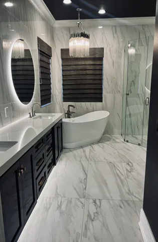 a spacious bathroom with a double vanity sink a large mirror and shower