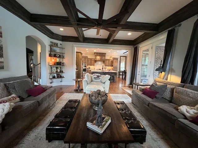 a living room with furniture and a chandelier