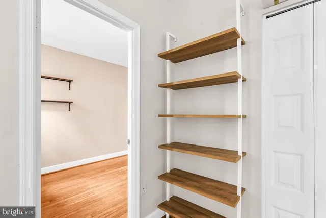 a view of an empty room with wooden floor