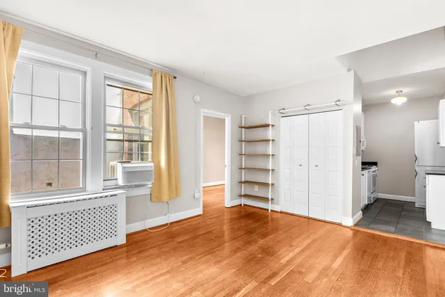 a view of empty room with wooden floor