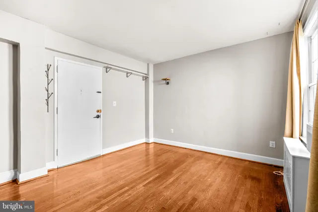 a kitchen with stainless steel appliances a refrigerator a stove and white cabinets