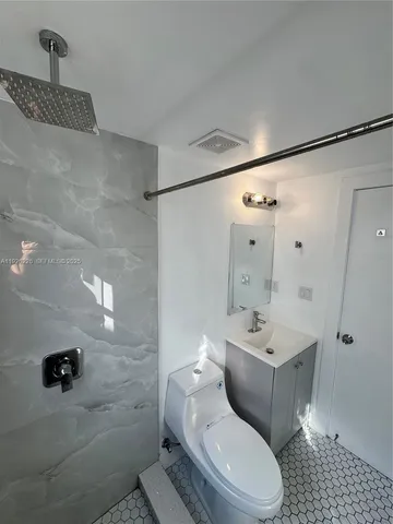 a white toilet sitting next to a bathroom sink