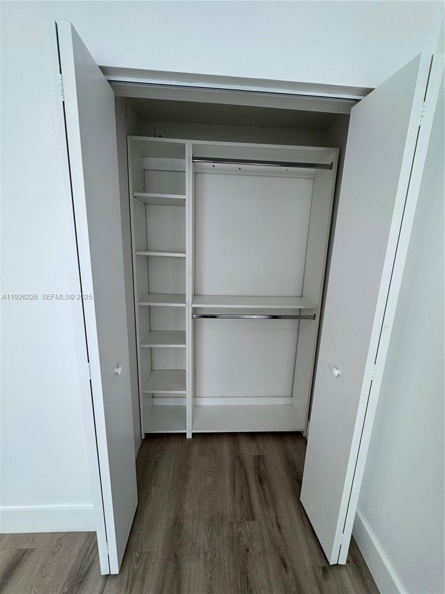 1969 Northwest 2nd Court, Unit 6 Miami, FL 33136 - Photo 16 of 17 a view of walk in closet with wooden floor