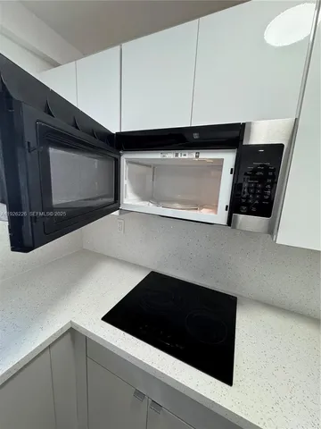 a kitchen with a sink and a microwave
